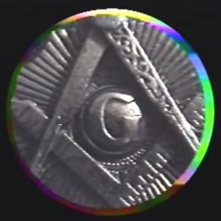 Coin close-up: masonic eye in a pyramid